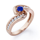 Spinning 0.7 carat Round Blue Sapphire and Moissanite Channel Engagement Ring in White Gold