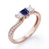 Scale Bridge Accent 0.65 carat Princess Blue Sapphire and Moissanite Twisted Wave Engagement Ring in Rose Gold