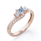 Trellis Three Stones 1 carat Princess Aquamarine and Moissanites Braided Engagement Ring in Rose Gold