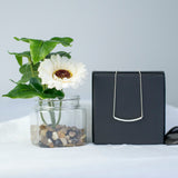 Curved Bar Round-Shaped Moissanite Pendant Necklace in 18K White Gold over Silver